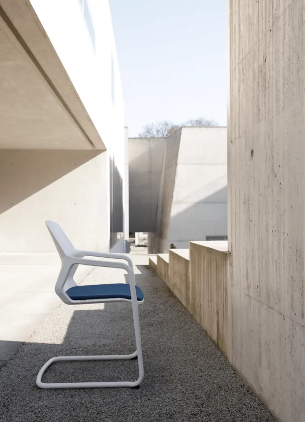 a modern chair in a brutalist backdrop
